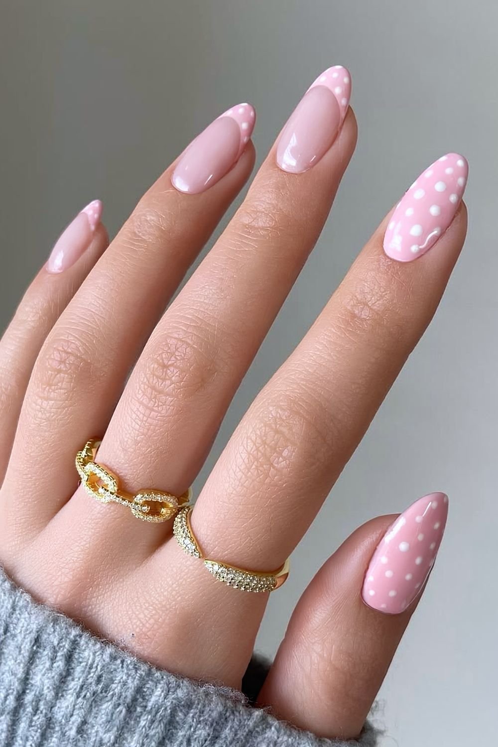 Baby pink nails with white polka dots and accent French tips