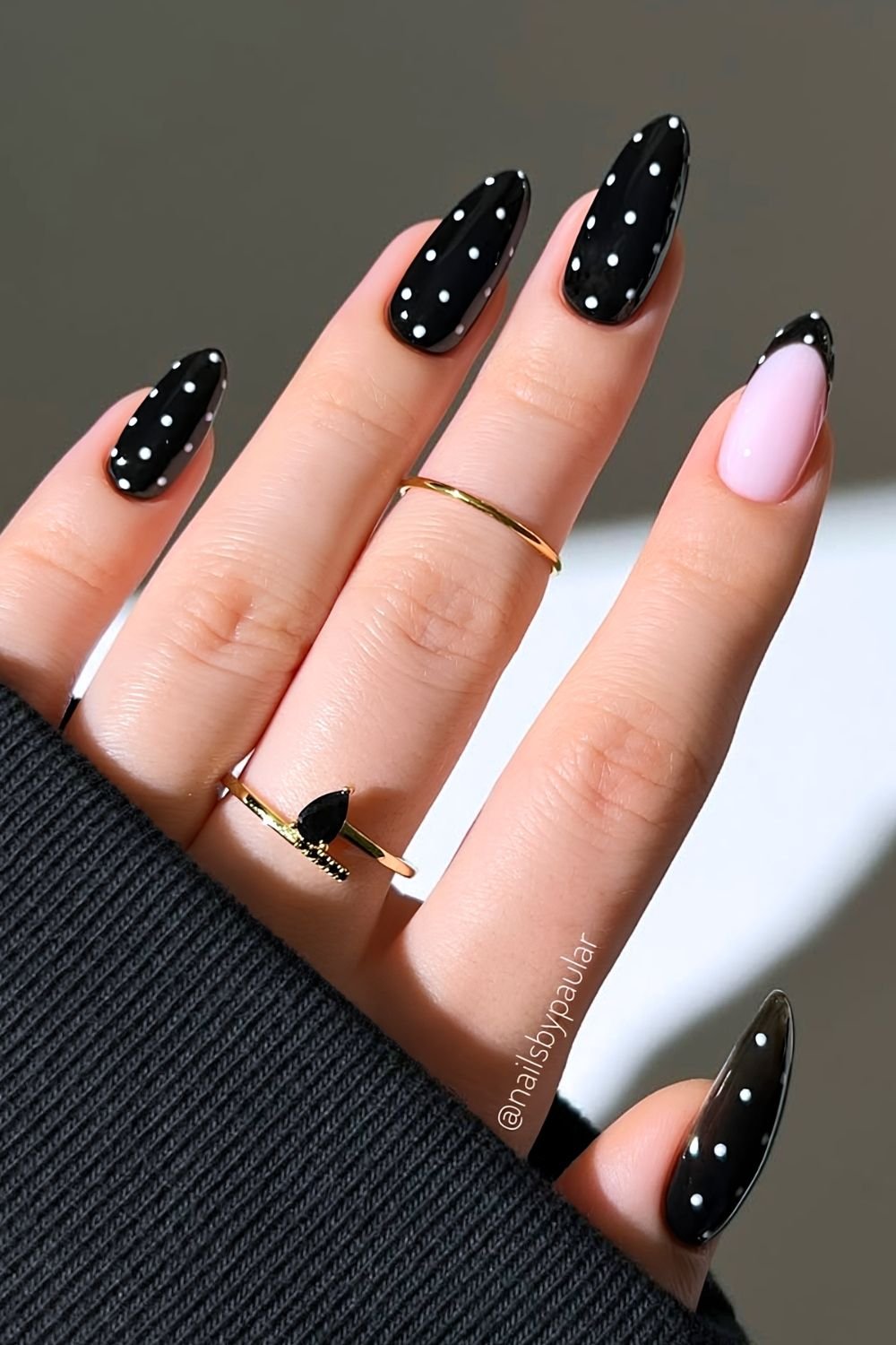 Black with white polka dot nails and one accent french tip