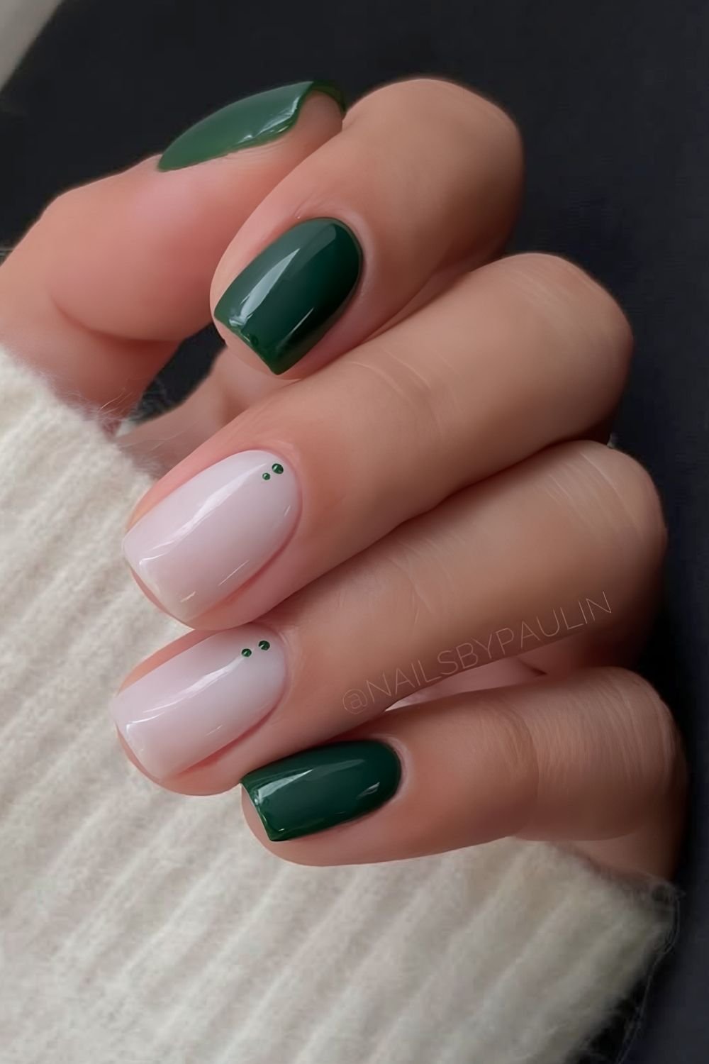 Dark green and milky white nails with dot accents on cuffs