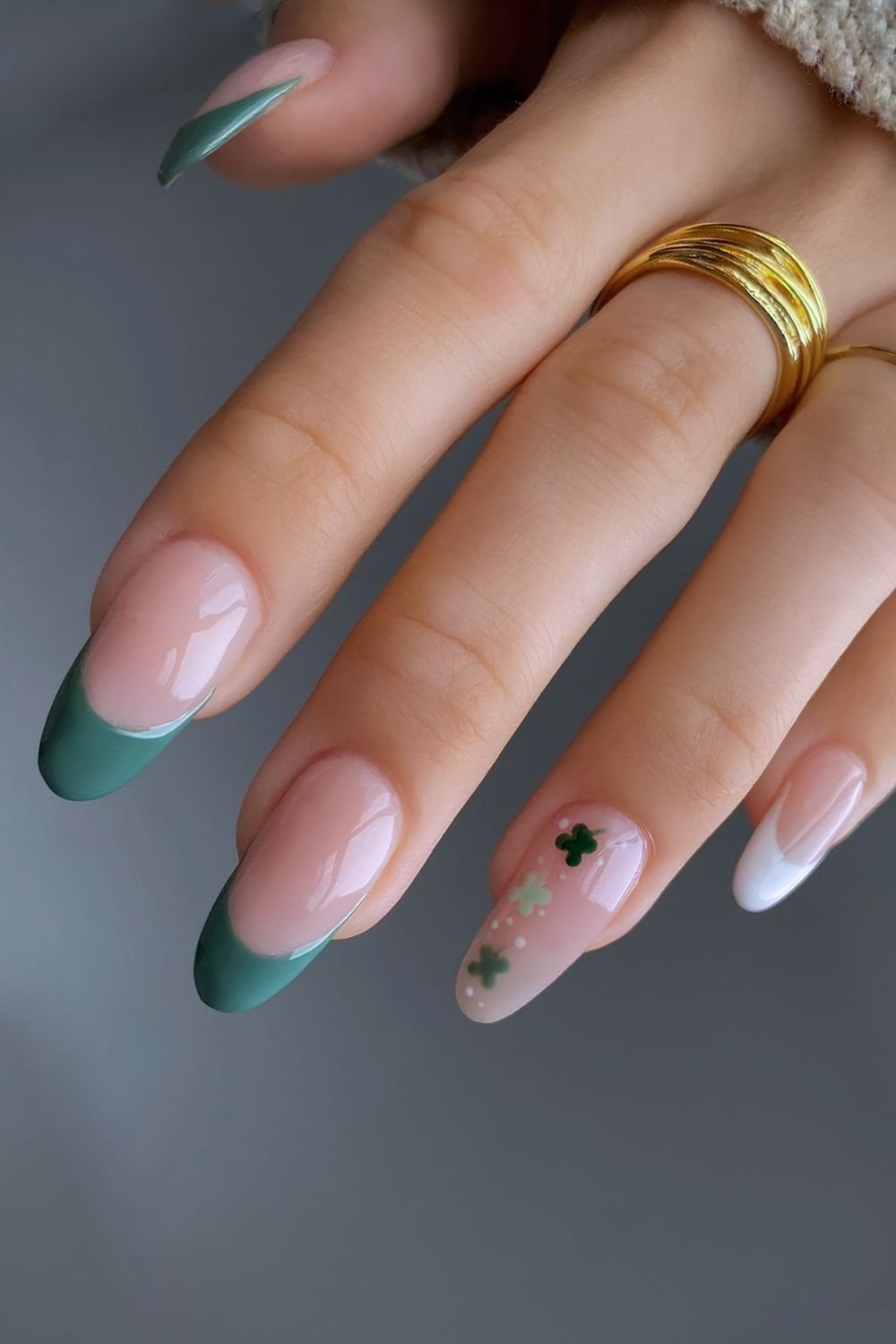 Emerald green nails with 3 small clovers on accent nails