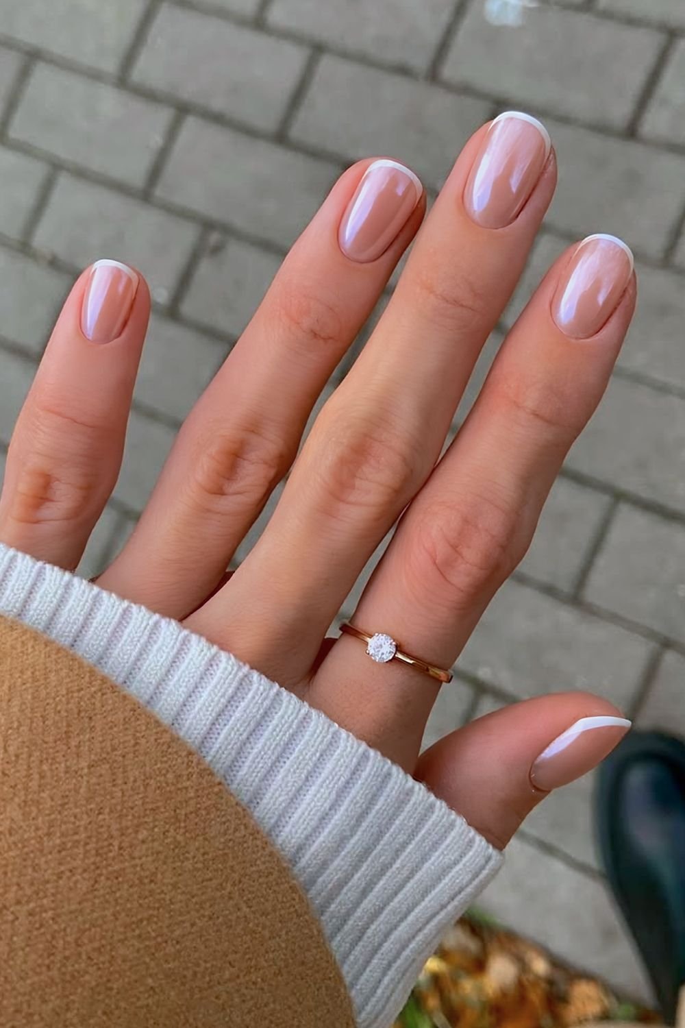 Glazed white micro French nails on a neutral base