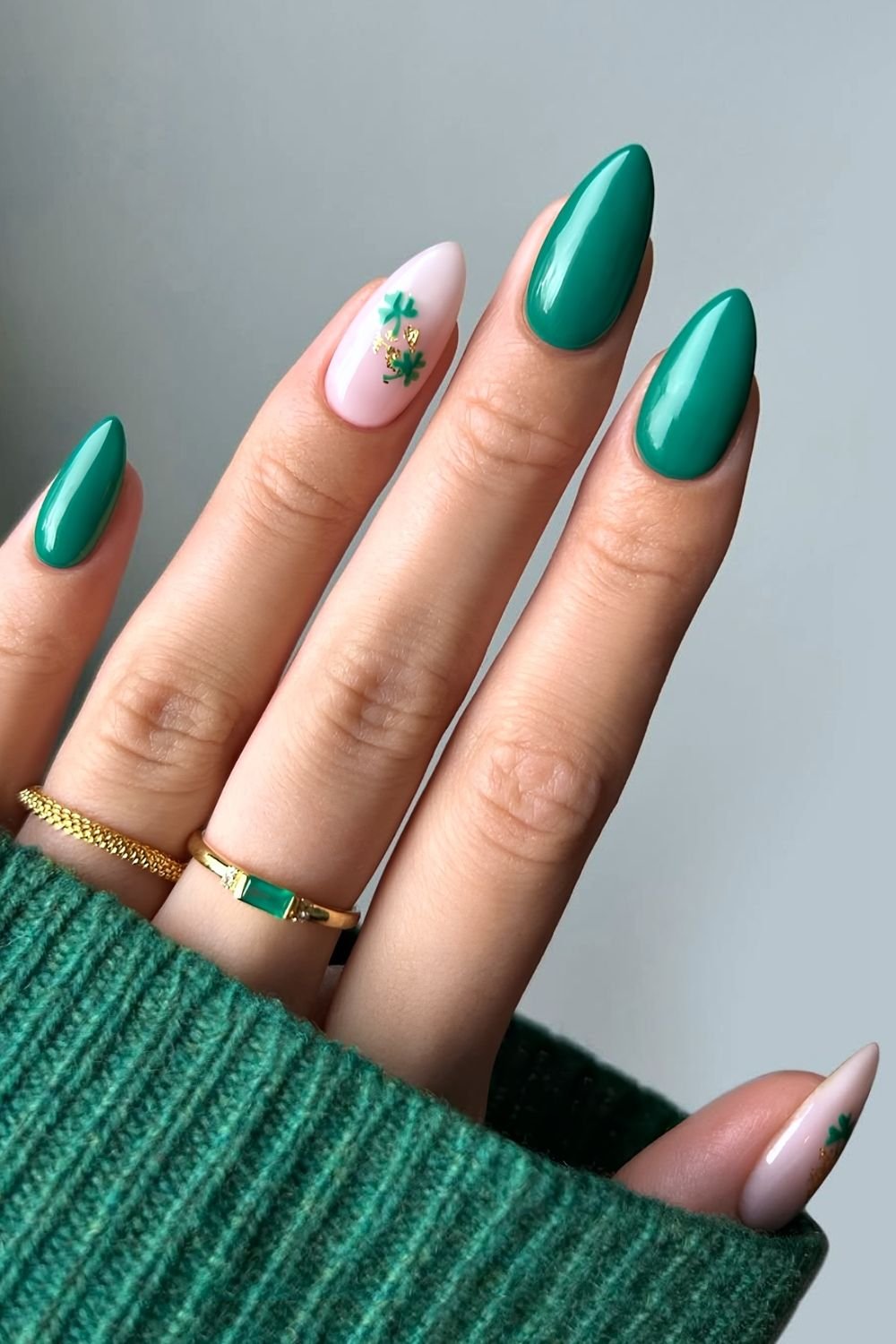 Green nails and milky white accent with tiny shamrocks and golden foil accents