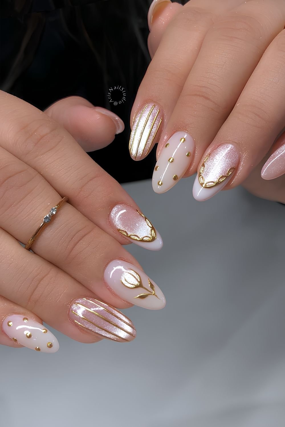 Light pink cat eye nails with golden chrome accents