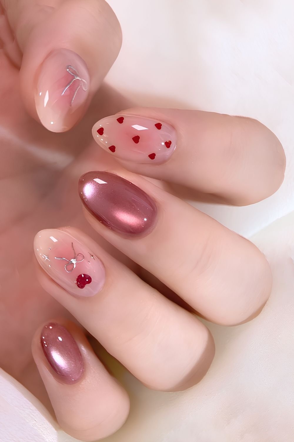 Mauve cat eye nails with pink aura and heart accents