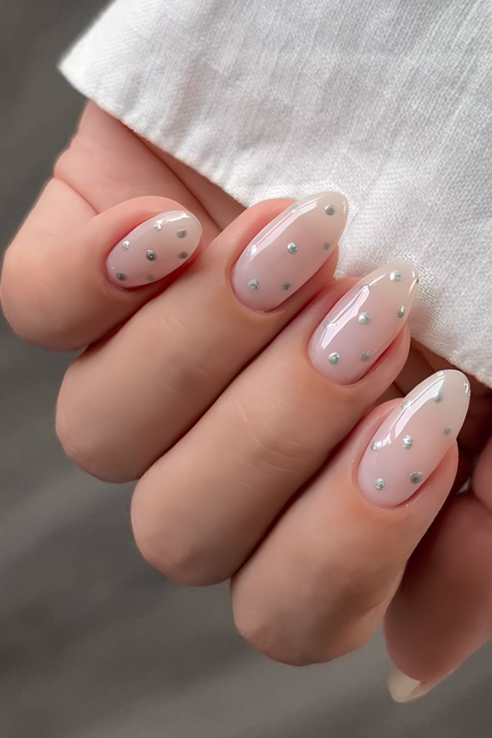 Milky white with silver chrome polka dot manicure