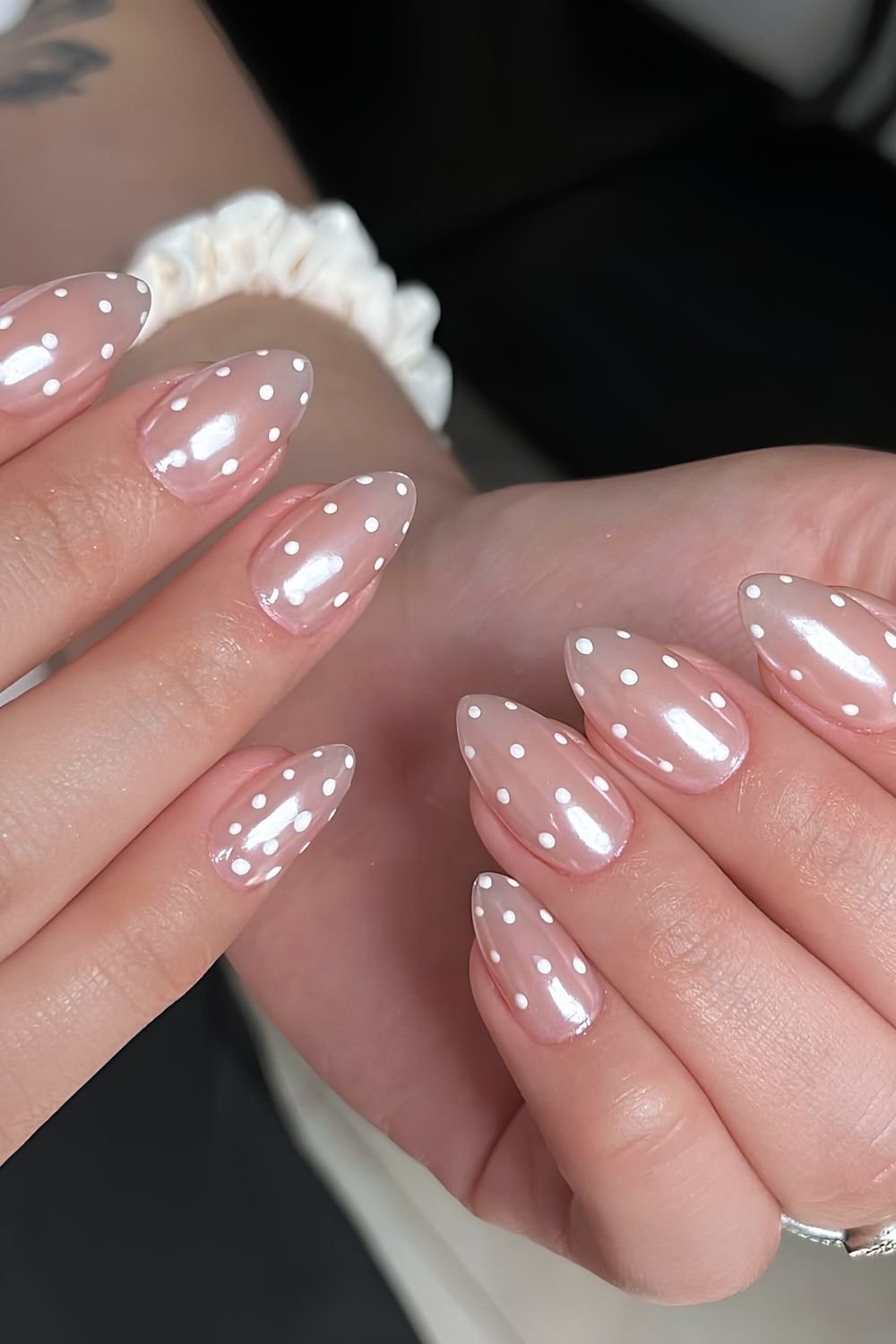 Neutral glazed nails with white polka dots