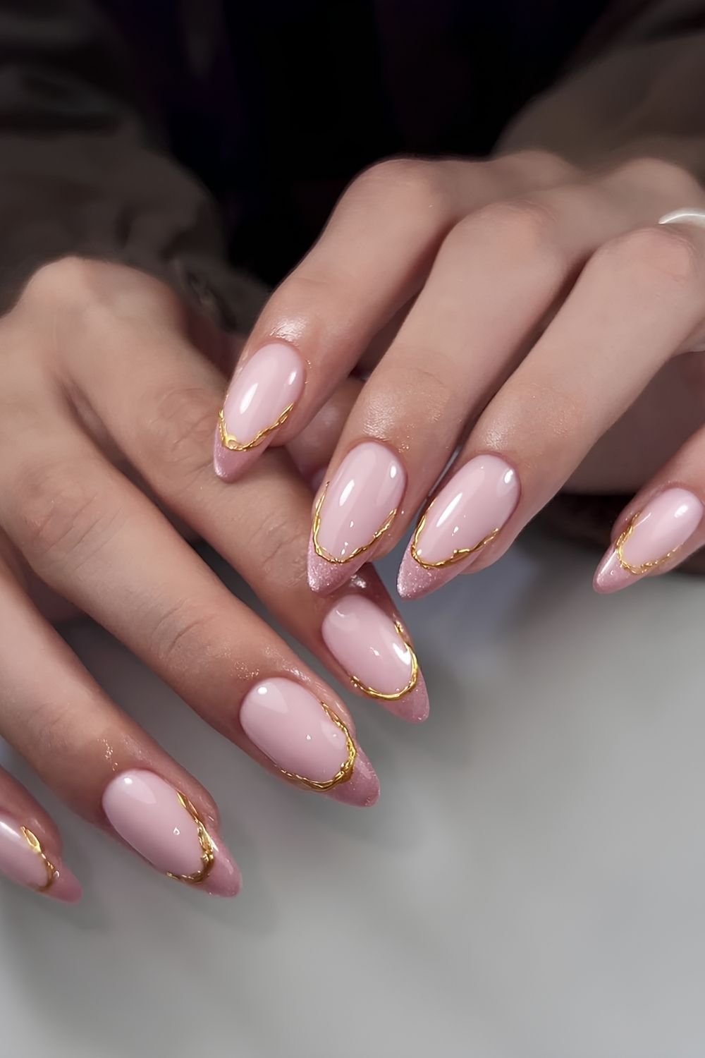 Pink cat eye French mani with gold chrome drip outline