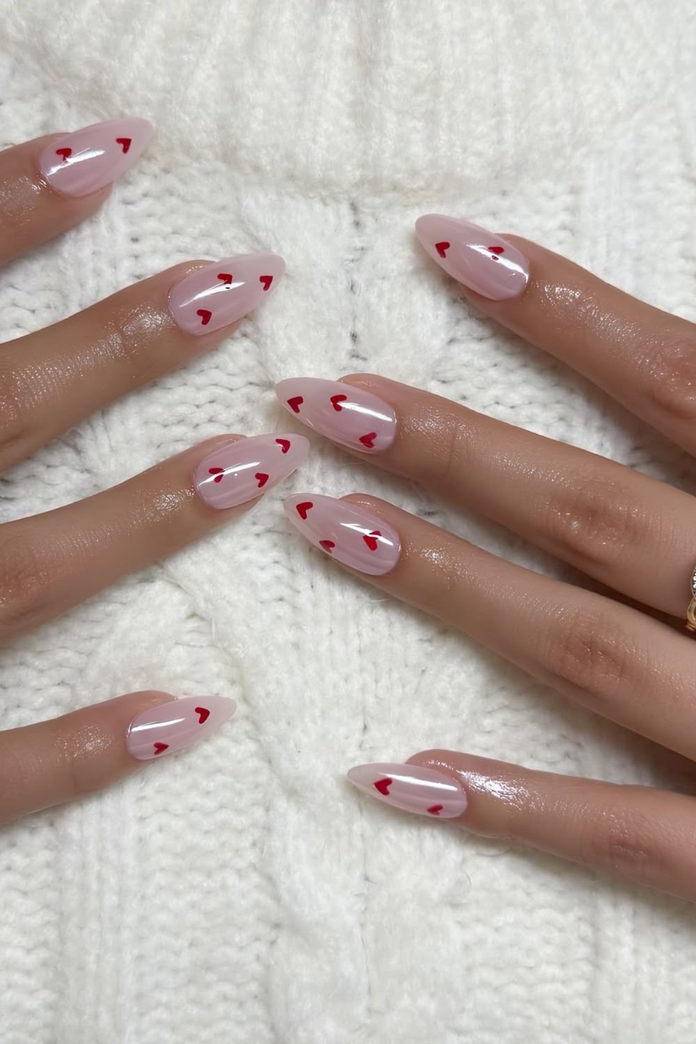 Pink chrome nails with tiny red hearts