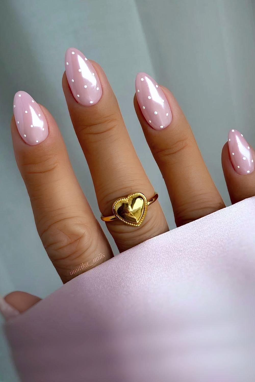 Pink chrome nails with white polka dots