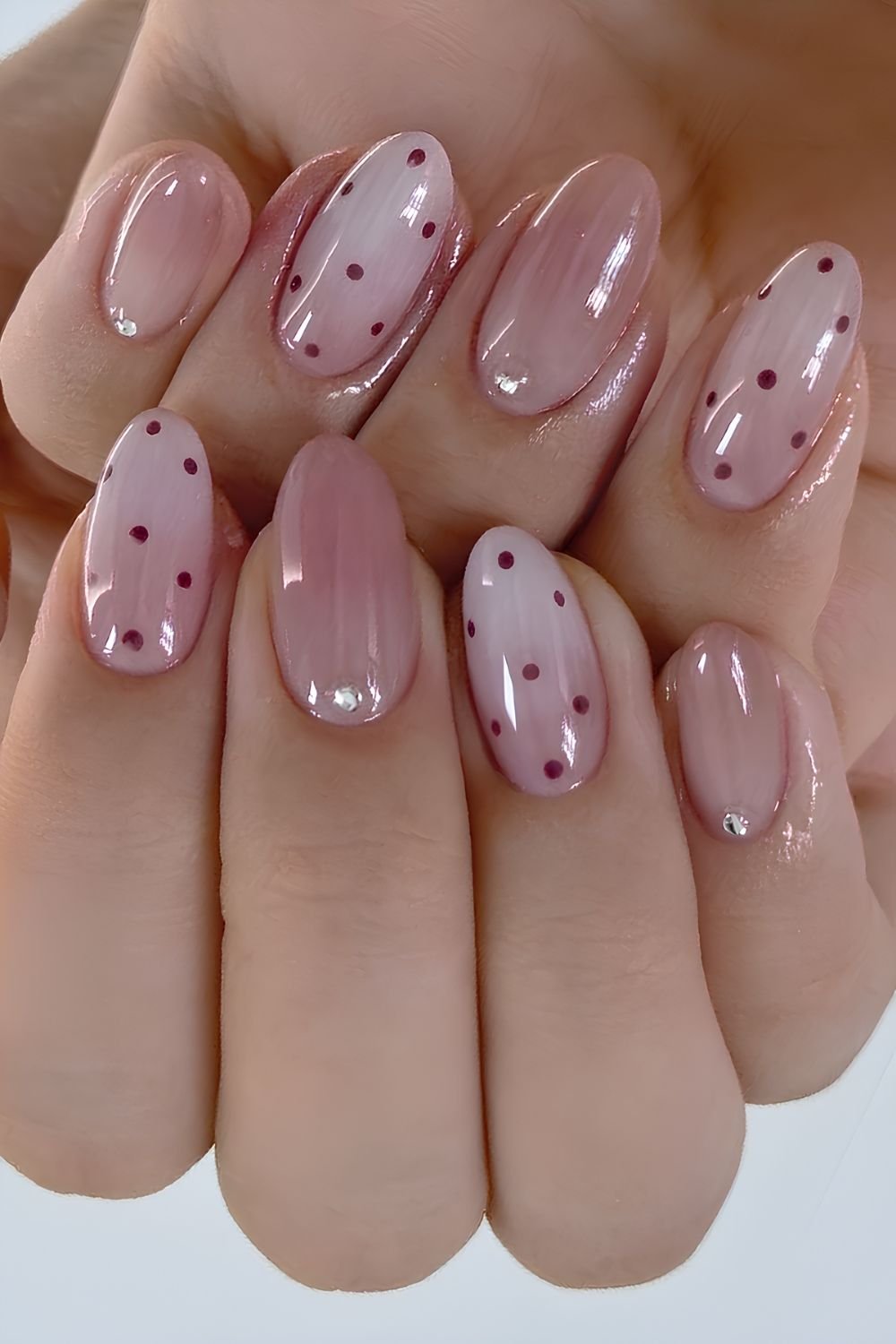 Pink to white ombre mani with accent polka dots and rhinestones