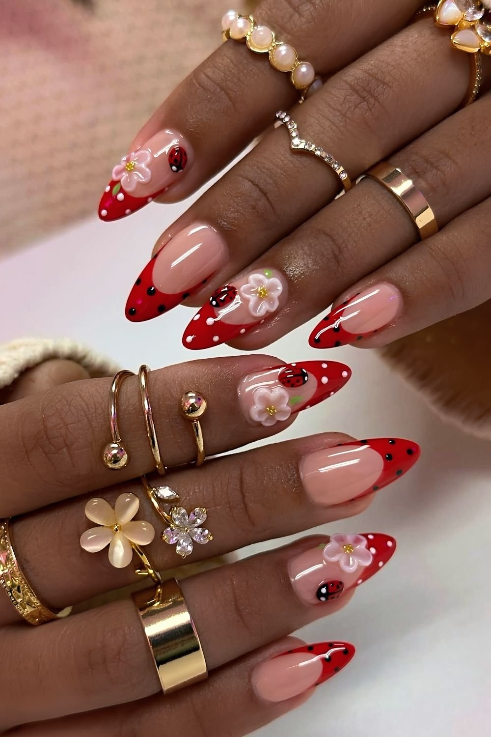 Red and black polka dot French nails with 3d ladybugs and florals