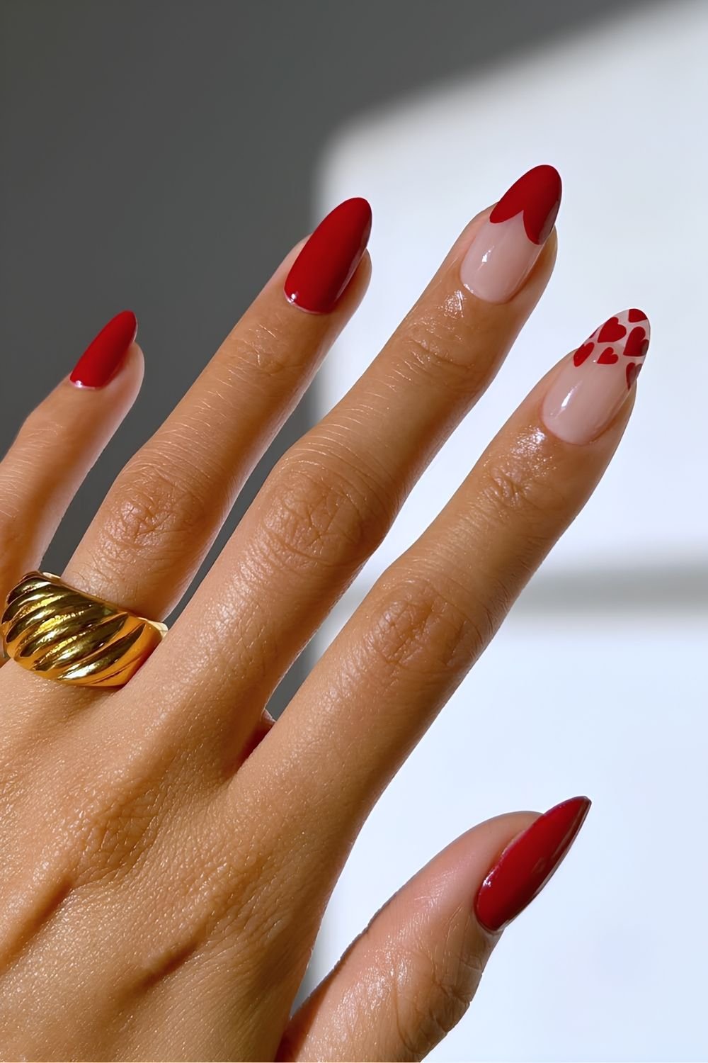 Red nails with heart shaped tip accents