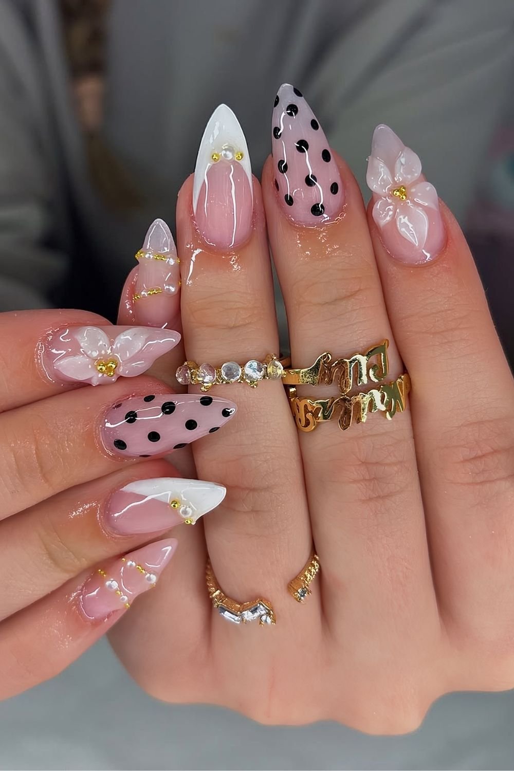 Sheer milky white nails with 3d florals, white french tips, pearls and black polka dots