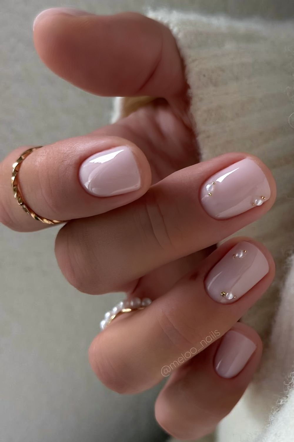 Short milky nails with pearl decals