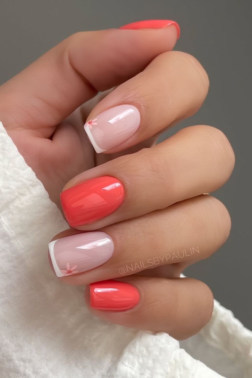 Short red coral nails with white french accents