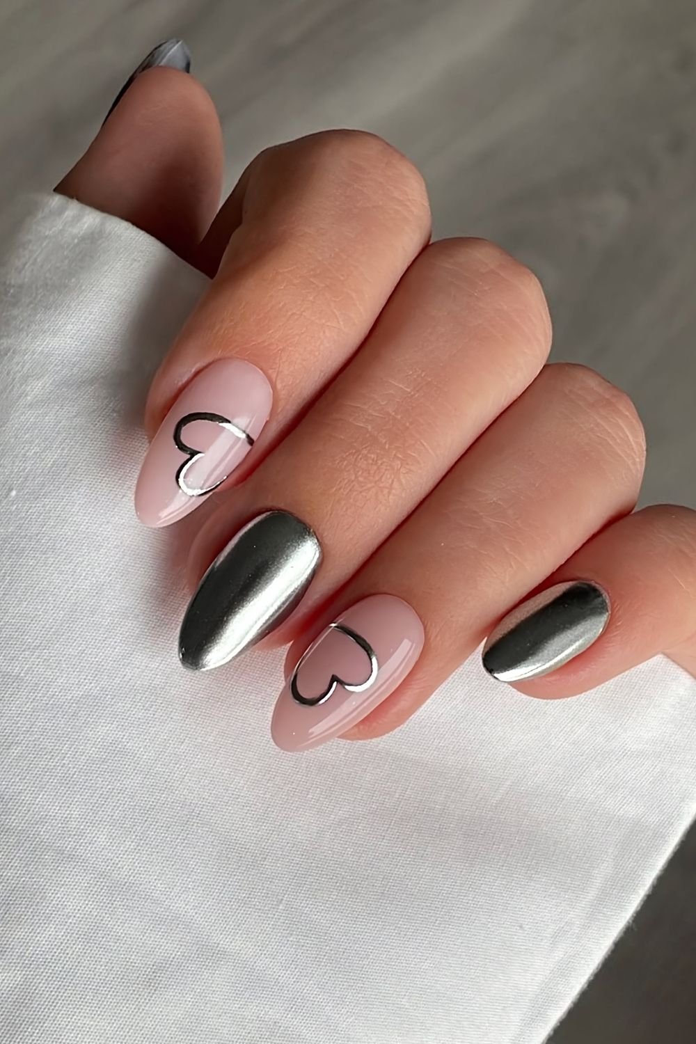 Silver chrome and milky pink nails with half-painted heart