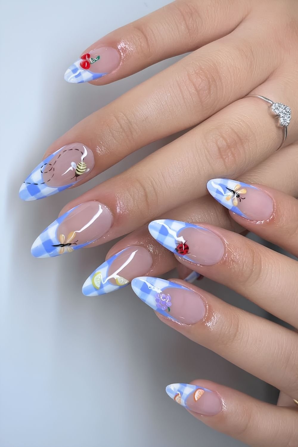 Blue and white checkered French tips with spring fruit and insect art