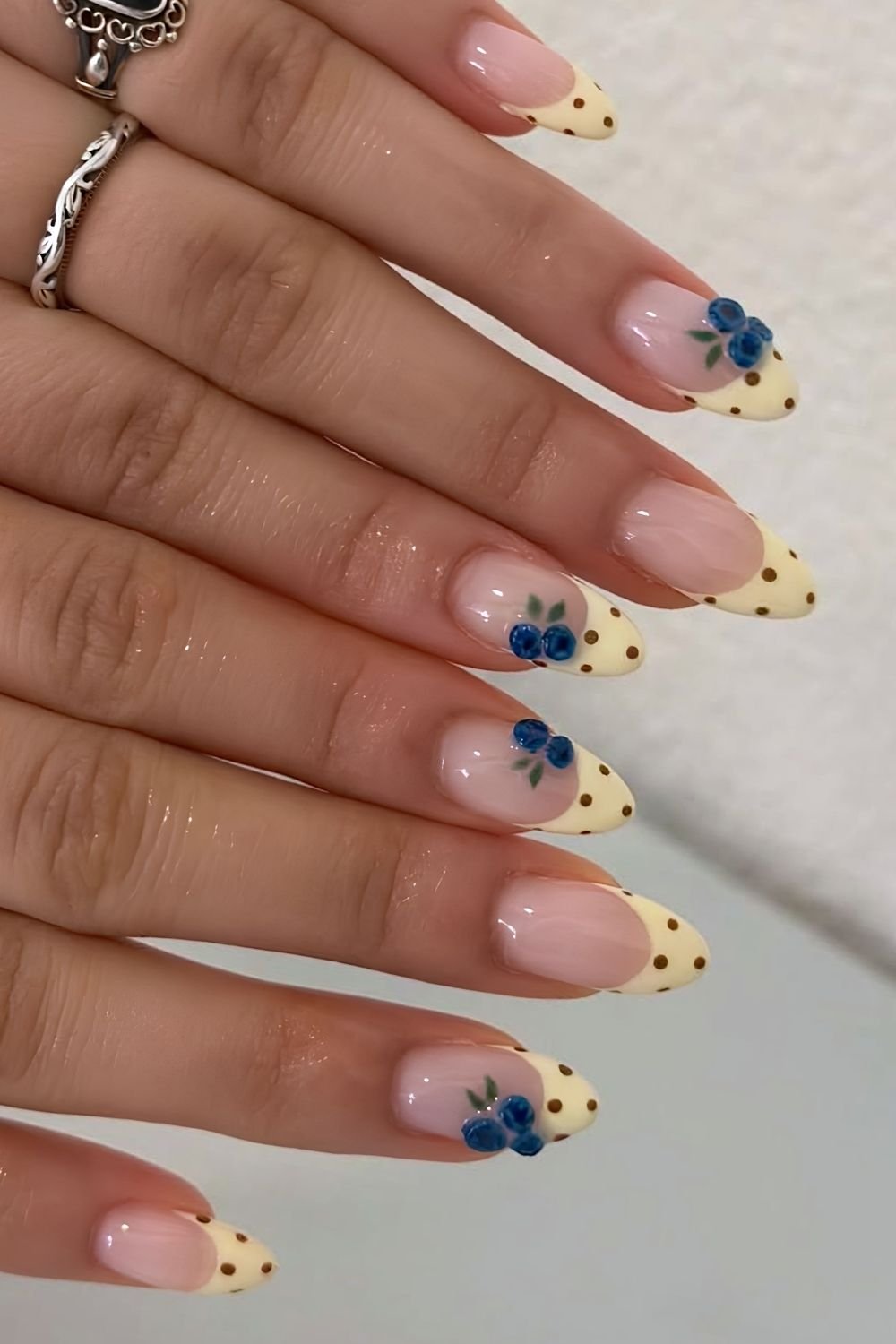 Butter yellow and brown polka dot French tips with blueberry accents