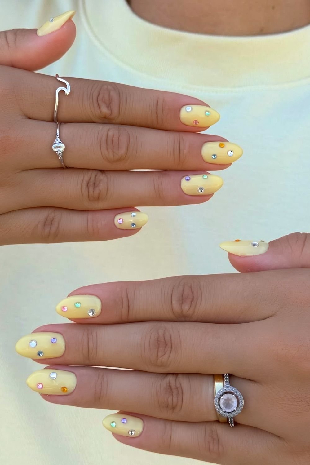Butter yellow nails with colorful rhinestones