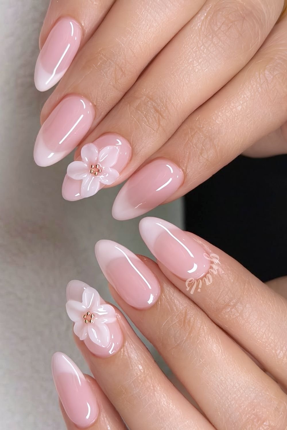 Cloudy light pink French tips with sculpted flower accents