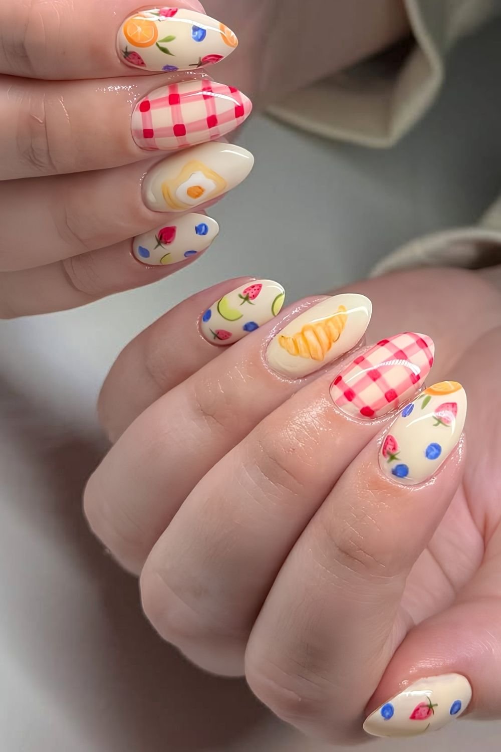 Creamy beige picnic nails with micro fruit and croissant design