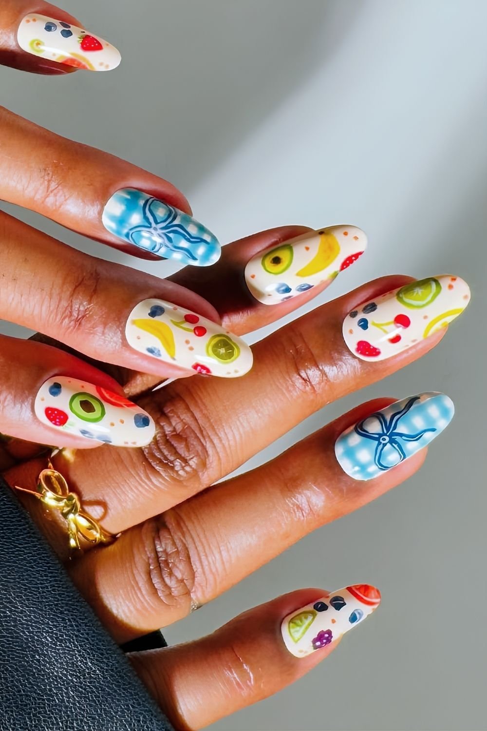 Fruit salad nail design with blue gingham accents