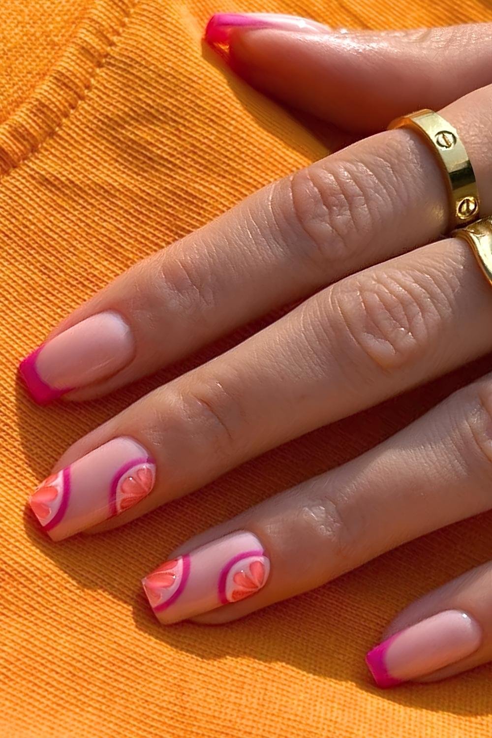Hot pink French nails with grapefruit slice design