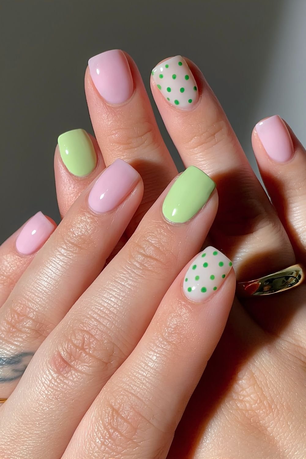 Matcha and sof pink nails with green polka dot accents
