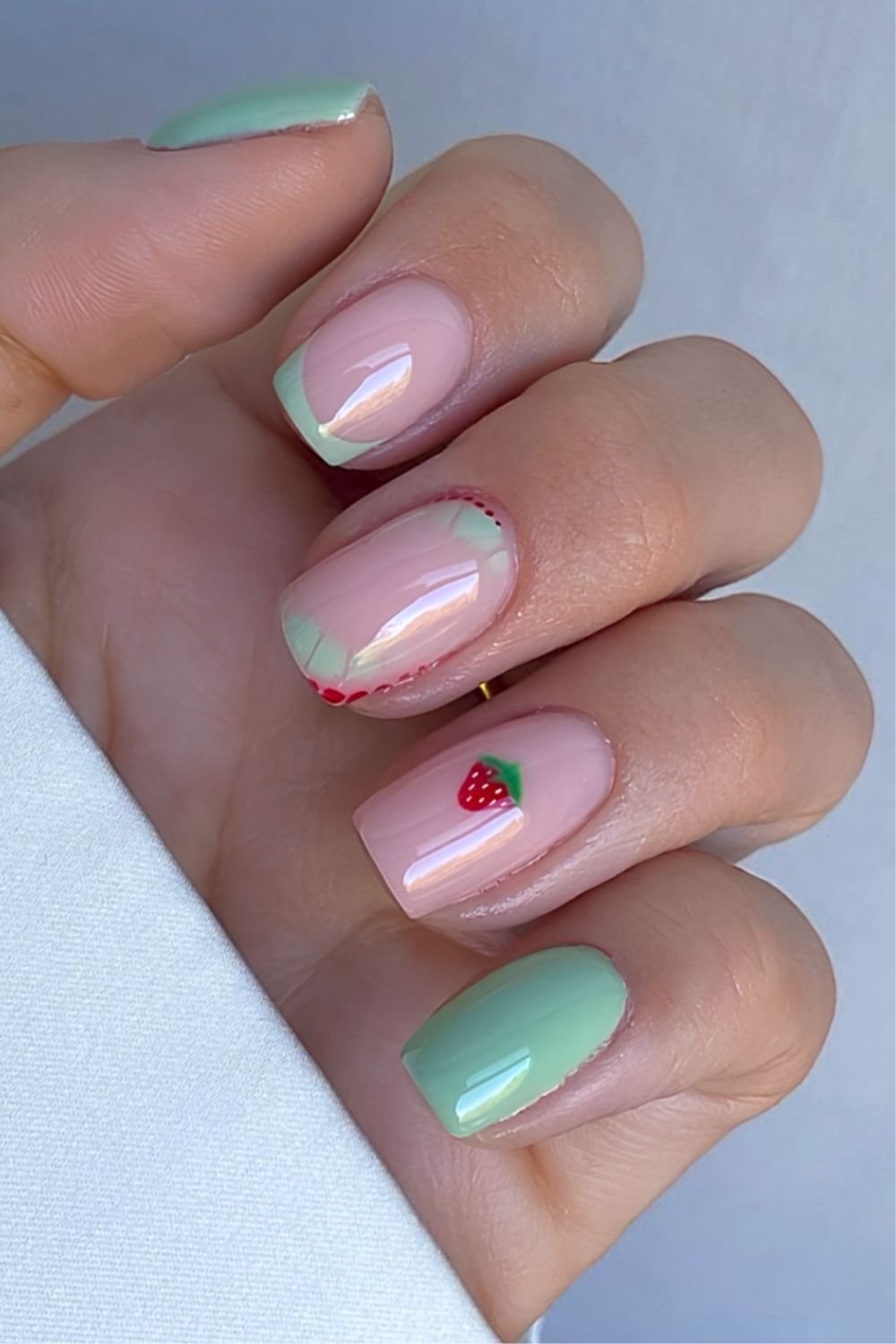 Matcha and soft pink nails with French tip, croc and strawberry accents