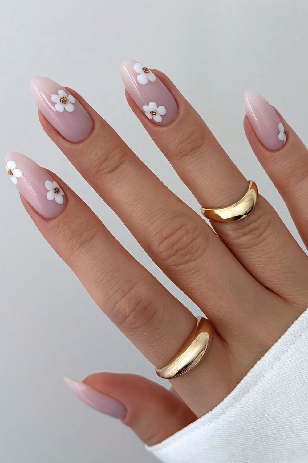 Milky white nails with white gem centered daisy design