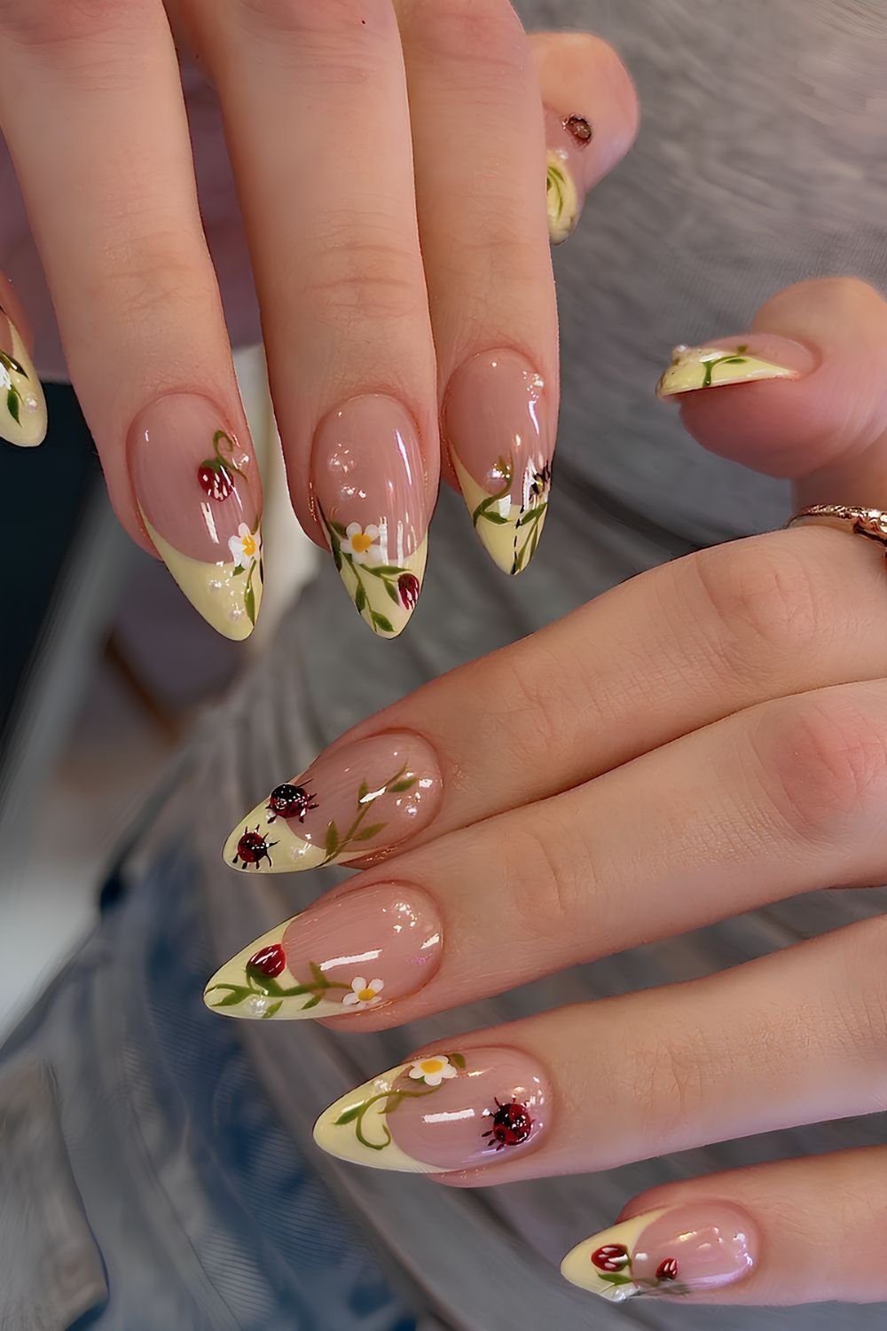 Pastel yellow French tips with ladybugs and strawberries