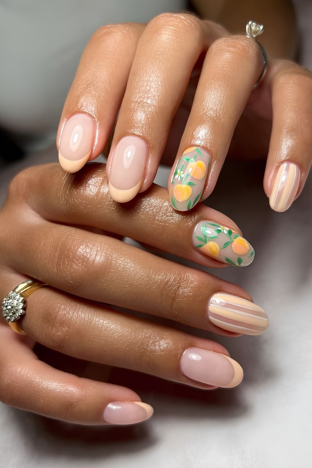 Peach French tip and striped nails with peach fruit accent nails