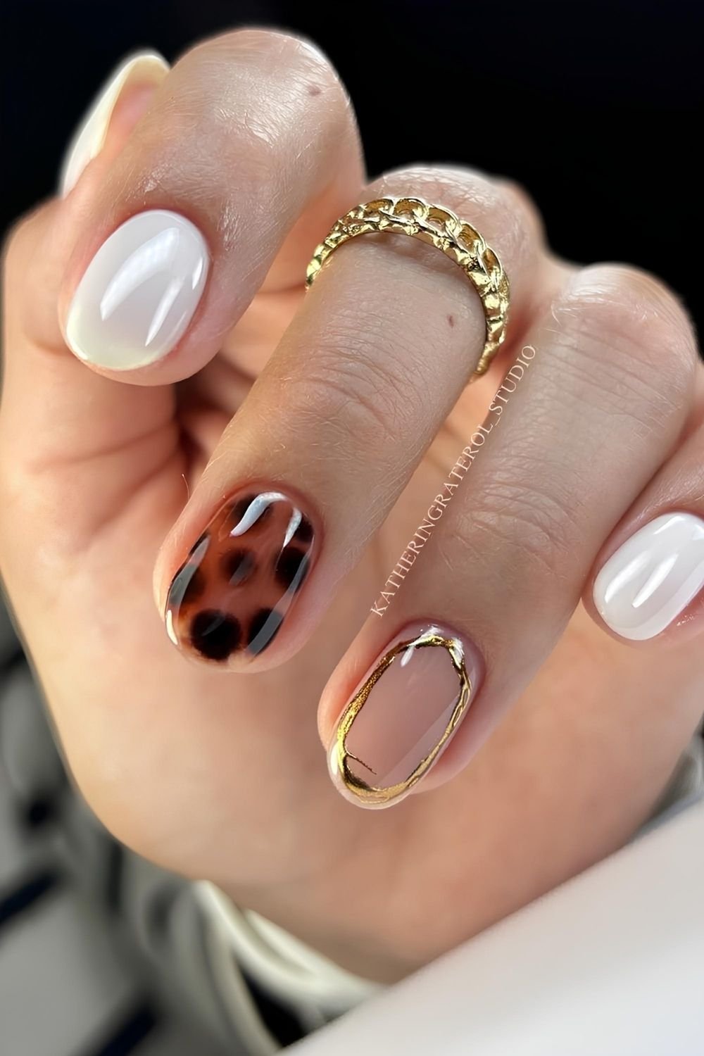 Pearly white nails with tortoise shell and gold chrome accents