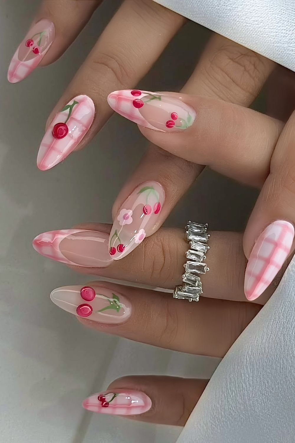 Pink gingham nails with cherry accents