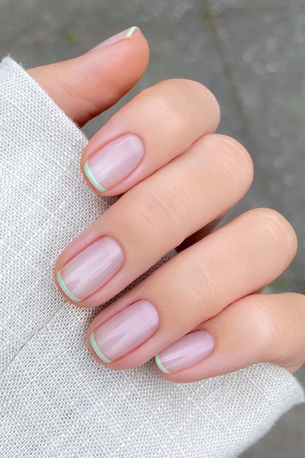 Pistachio green micro French tip nails