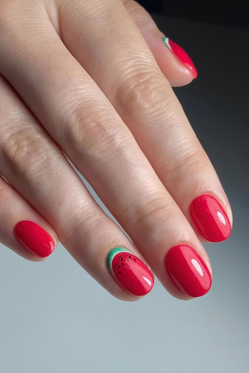 Red nails with sliced watermellon design