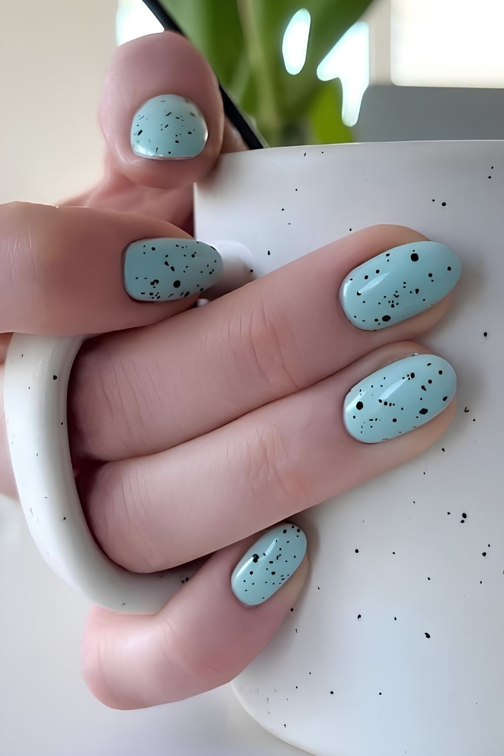 Robin’s egg blue nails with black speckles
