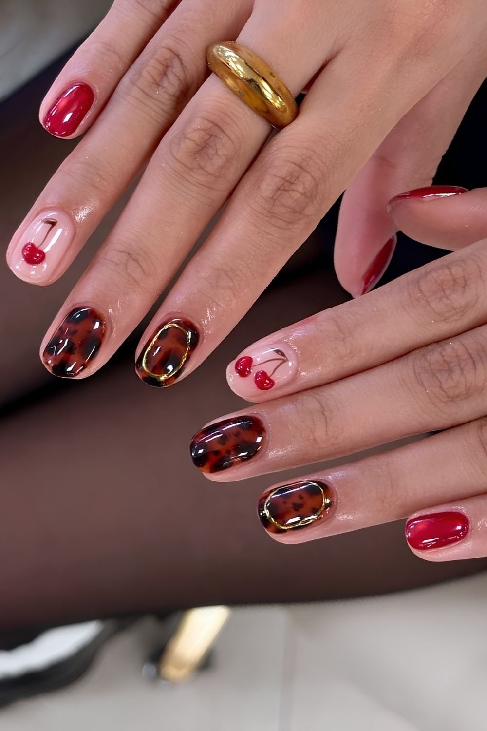 Tortoise shell and red cat eye nails with cherry accents