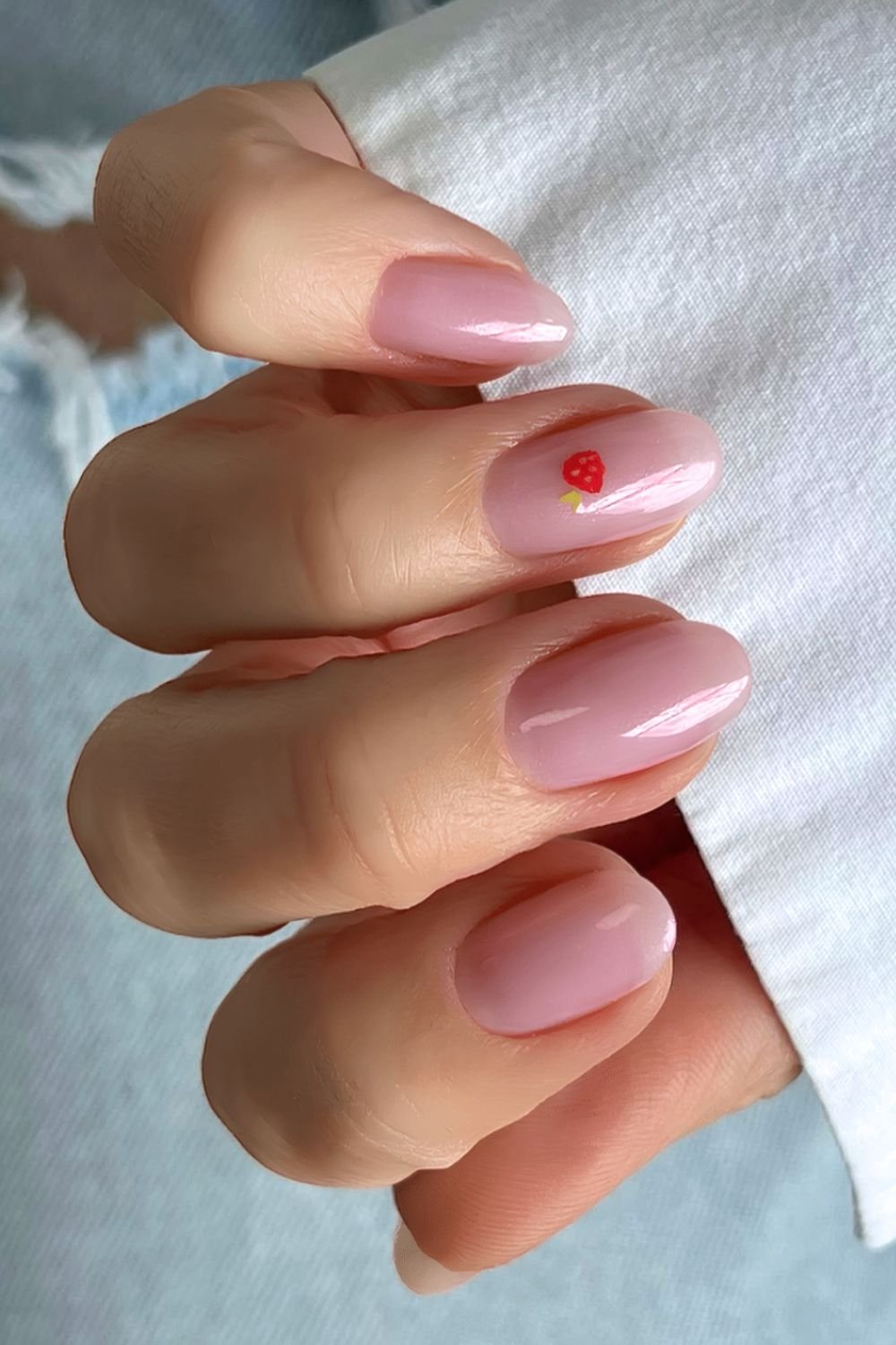 Watery pink nails with strawberry accent