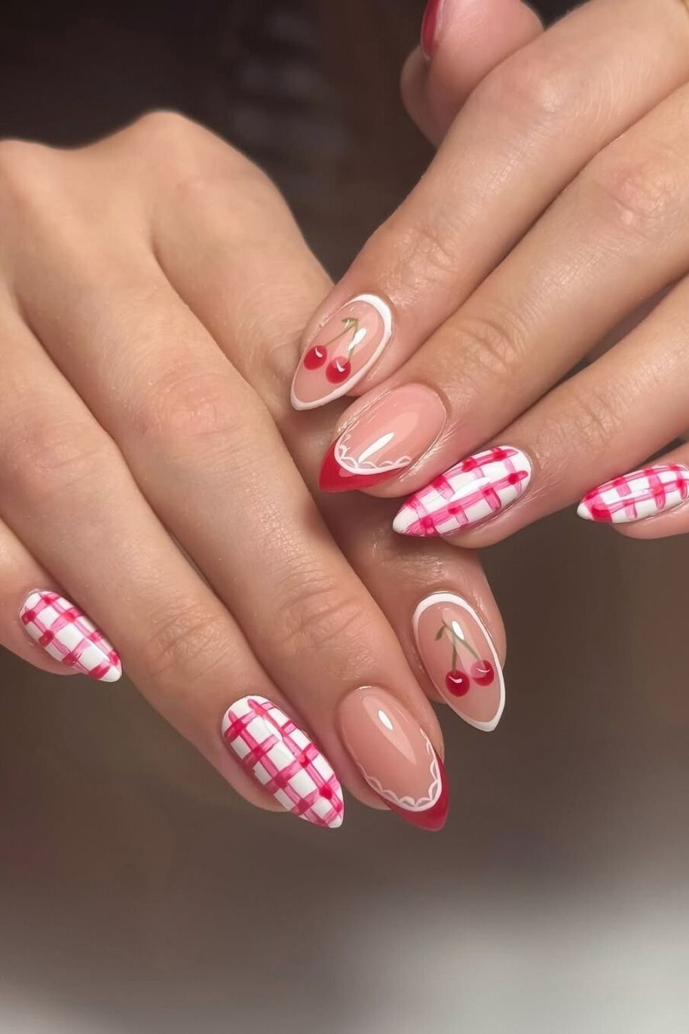 White and red gingham nails with cherry accents
