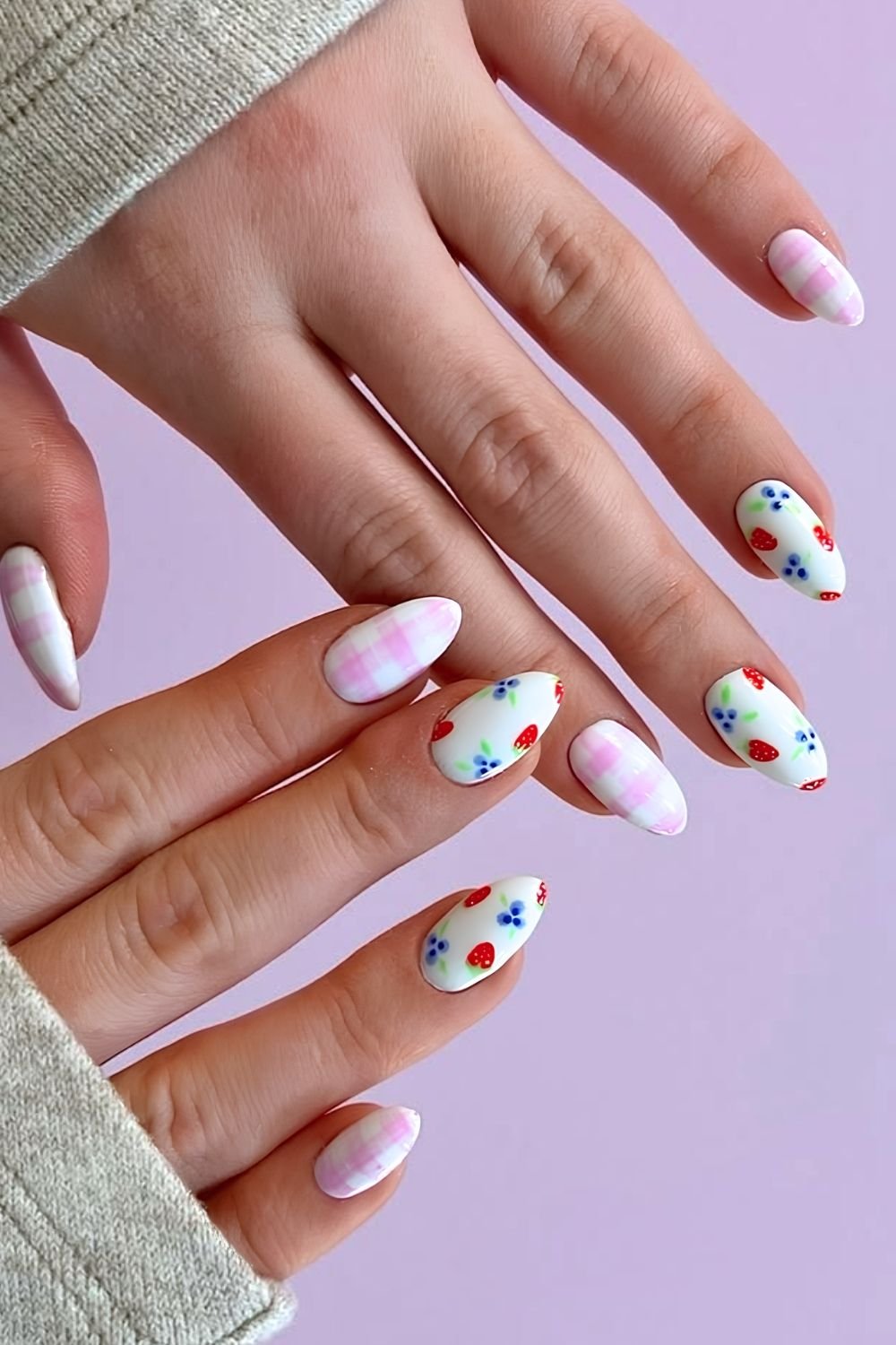 White nails with pink gingham patterns and berry nail art