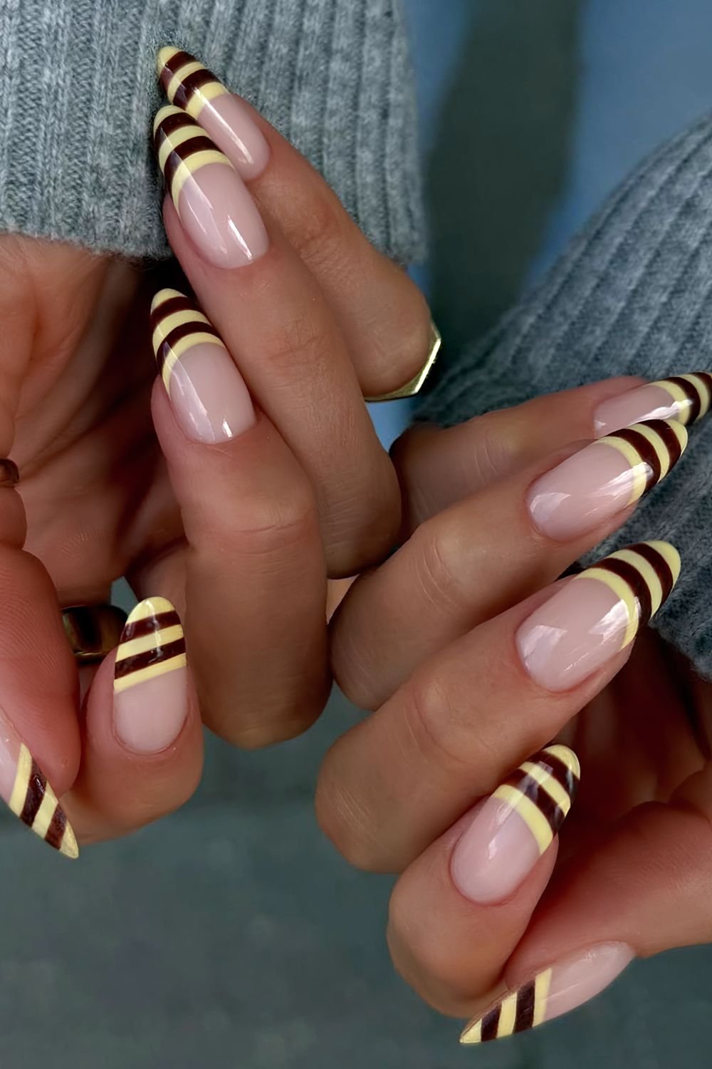 Bee inspired by a dark brown and yellow striped French manicure