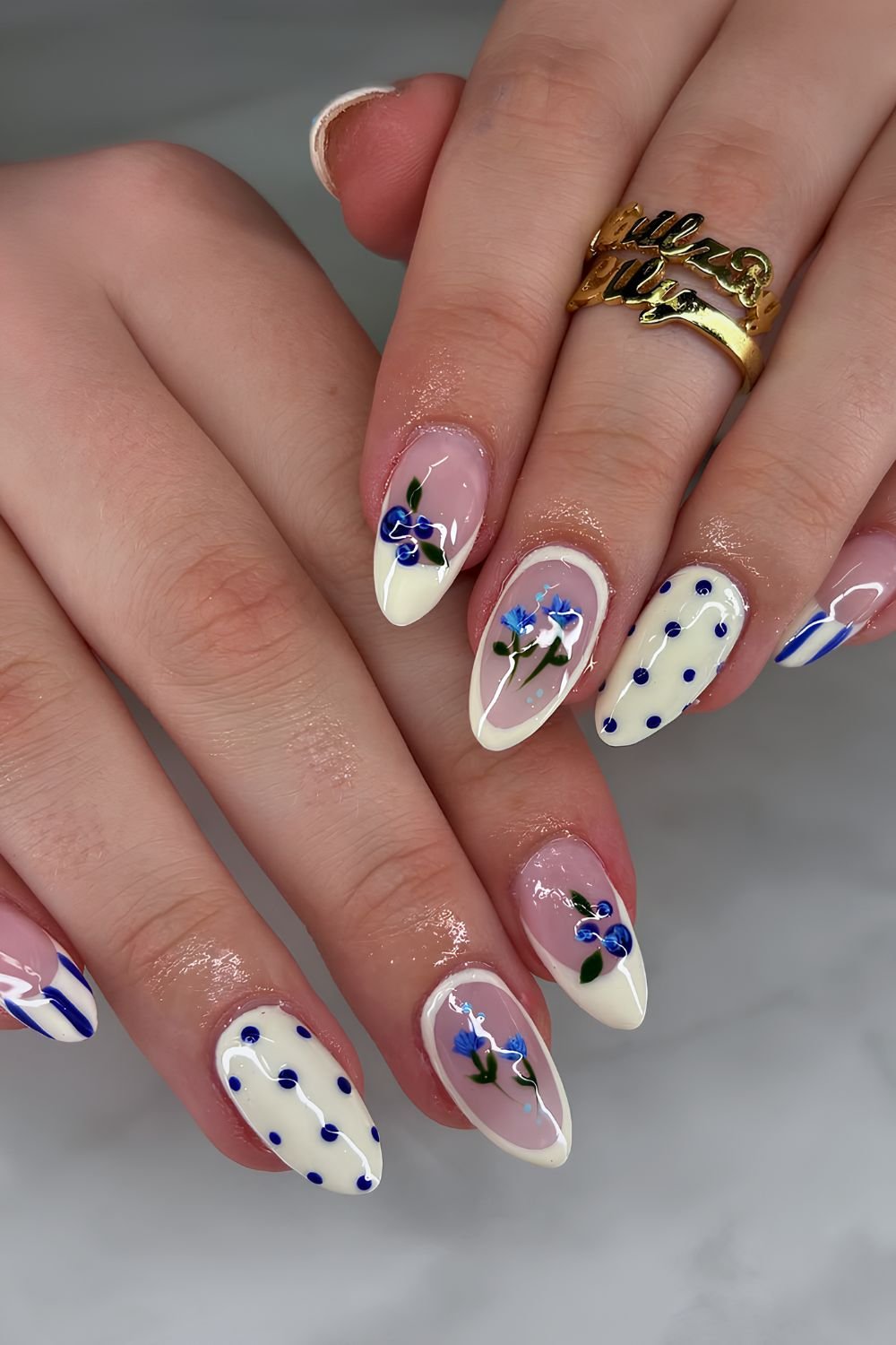 Blue and yellow stripes and polka dots nails with blueberries and blue florals