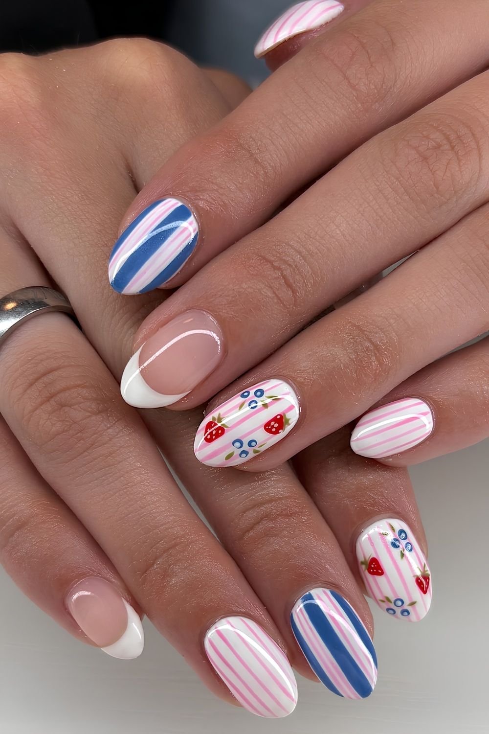 Blue, white and pink striped nails with fruit