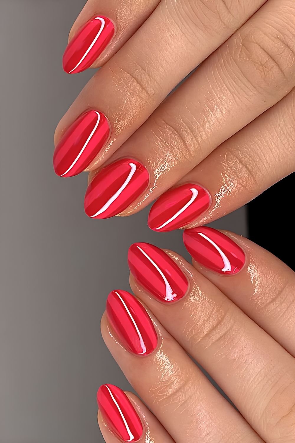 Bright and dark red striped manicure