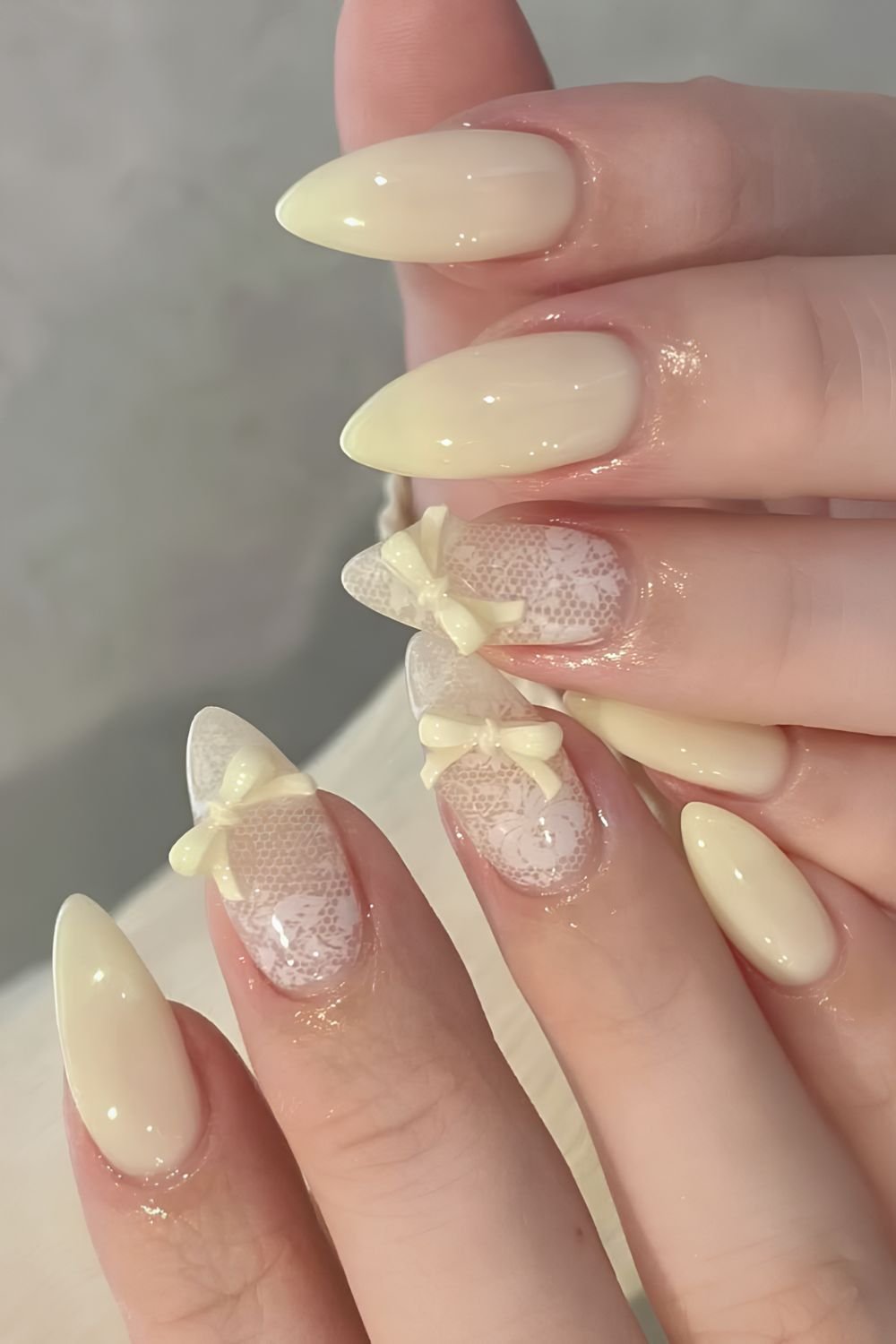 Butter yellow lace nail design with 3D bows