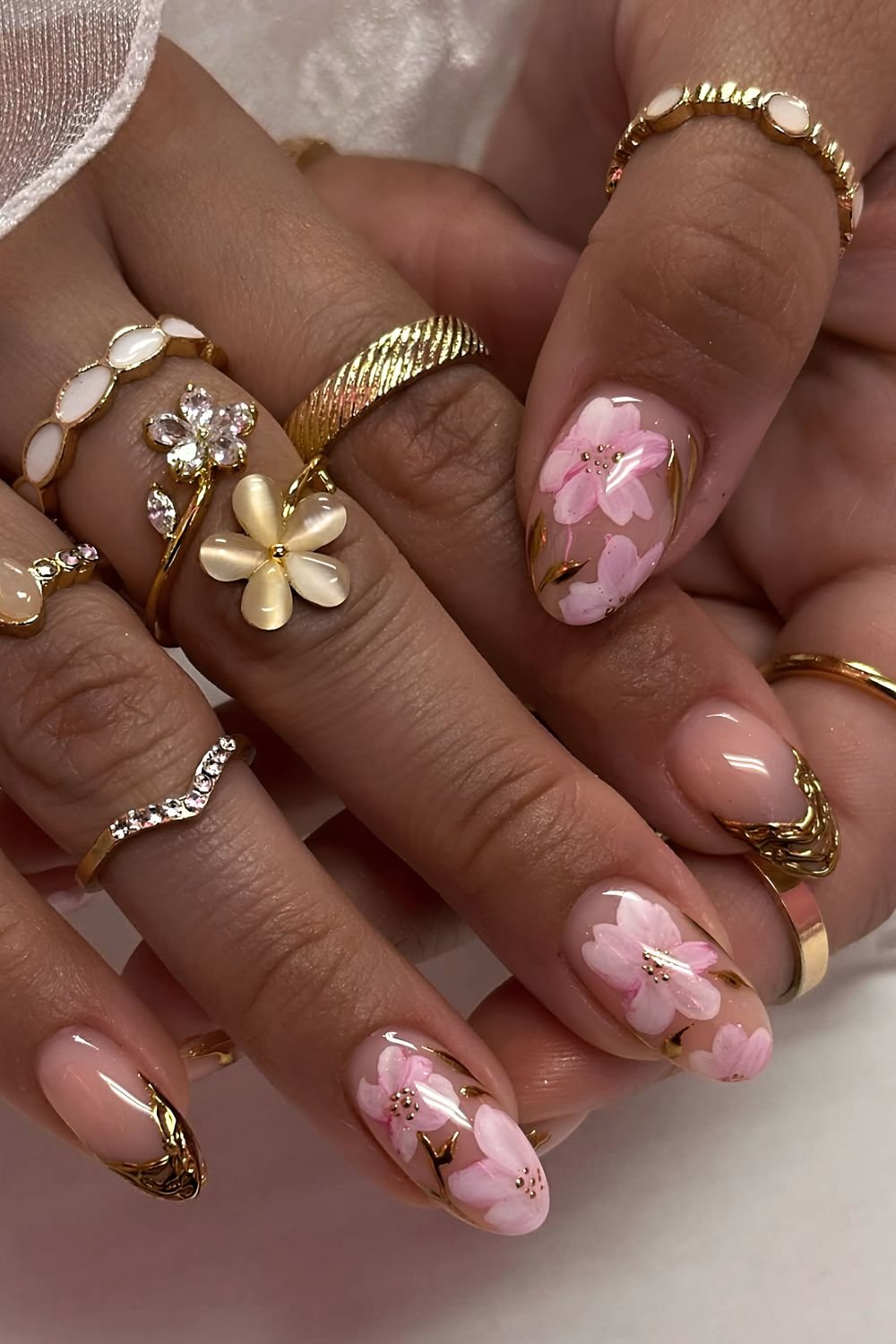 Cherry blosom nails with golden chrome drip tips and accents