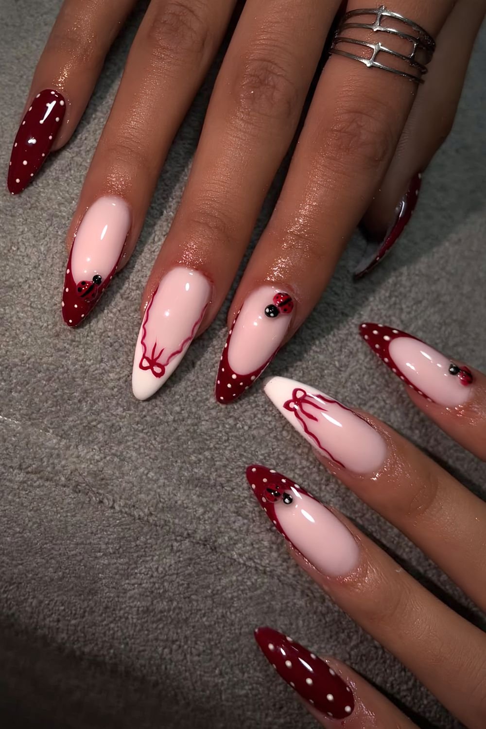 Cherry red and white polka dot French manicure with white french tip accents and bows and 3d ladybugsherry