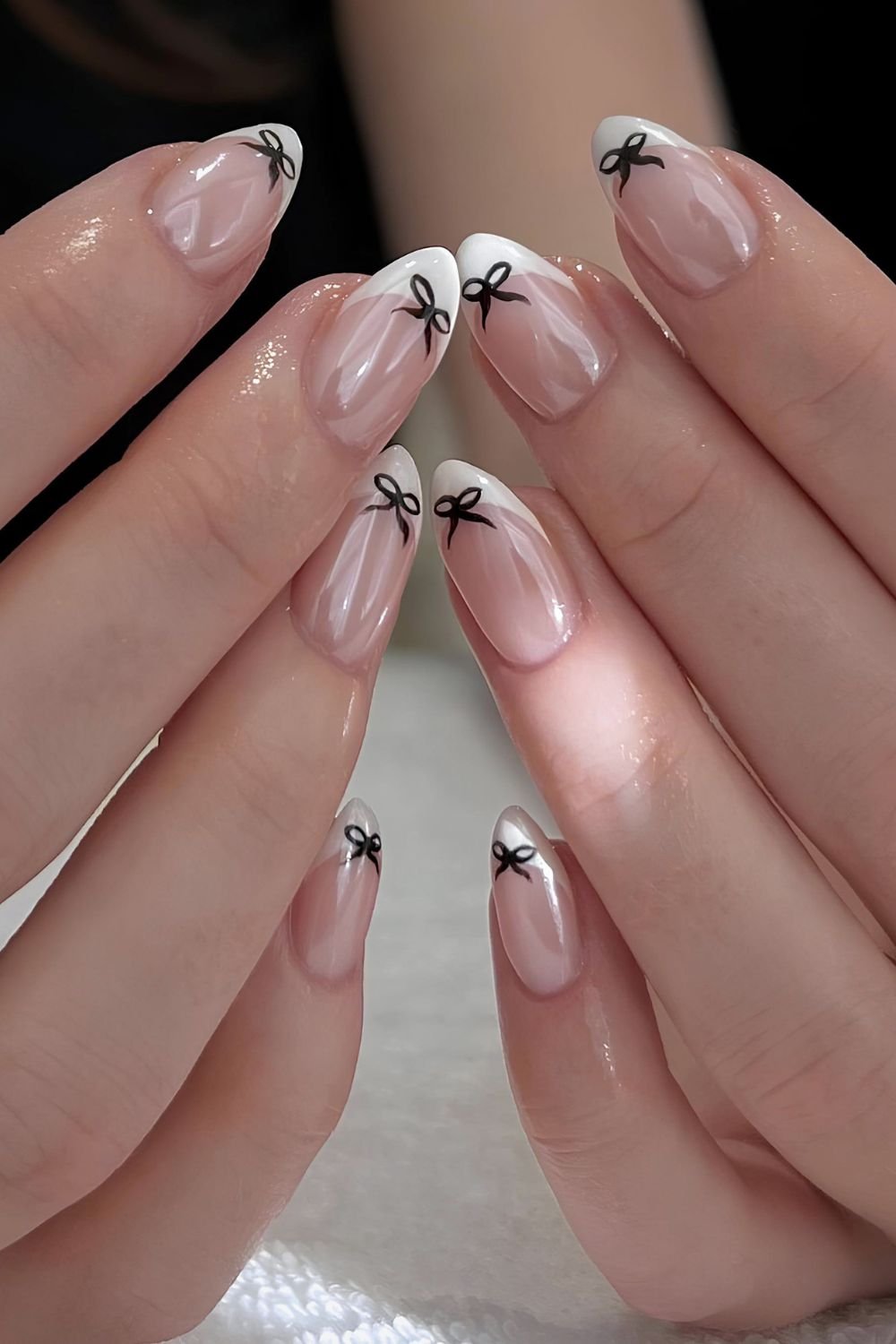 Glazed white french tip nails with bow designs