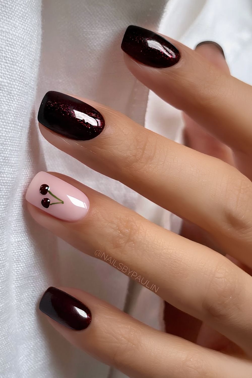 Glittery black cherry nails with cherry accents